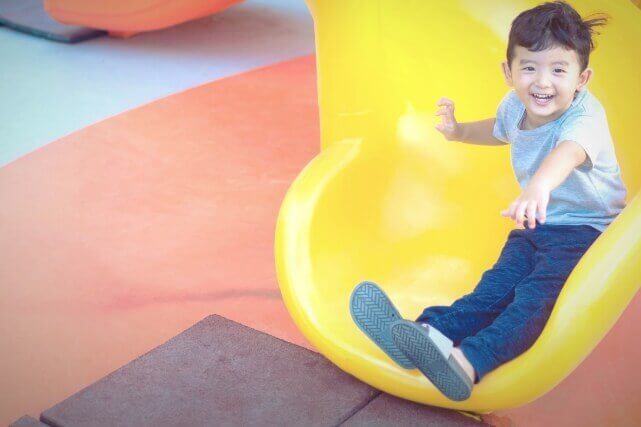 Kid On Yellow Slide