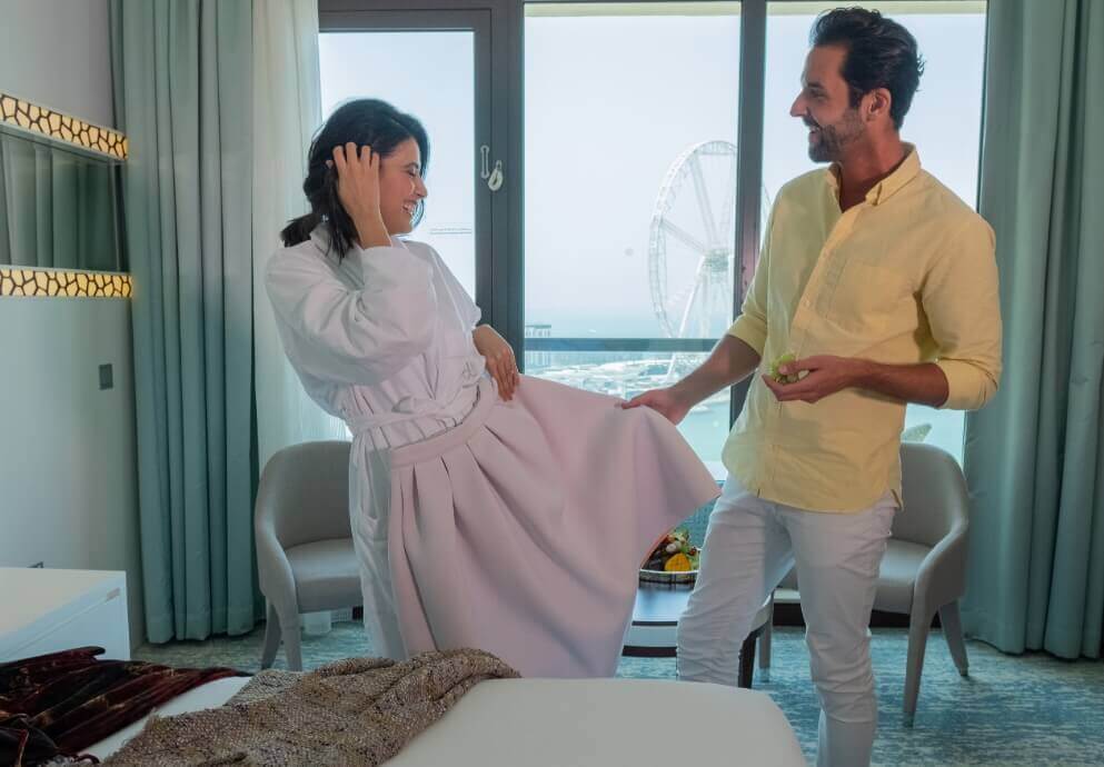 Couple Getting Ready In Resort Suite