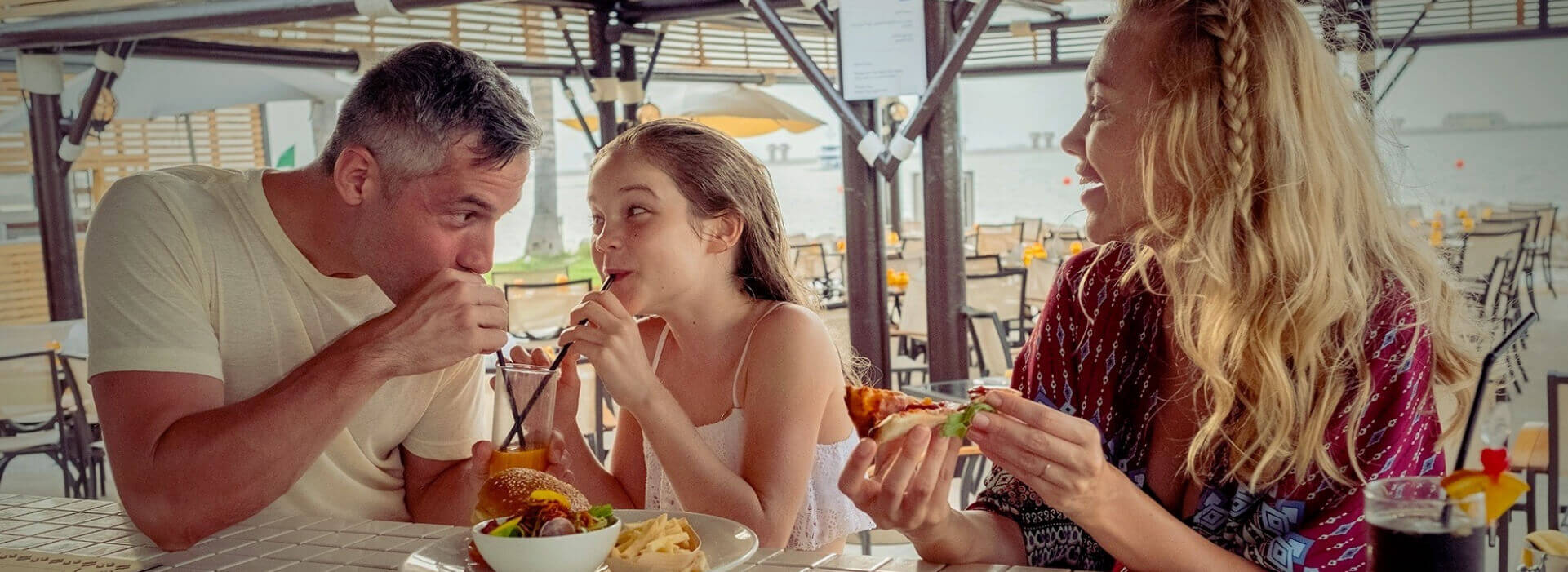 Family Eating Burgers And Pizza