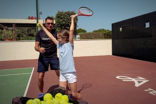 Girl Learning to Play Tennis