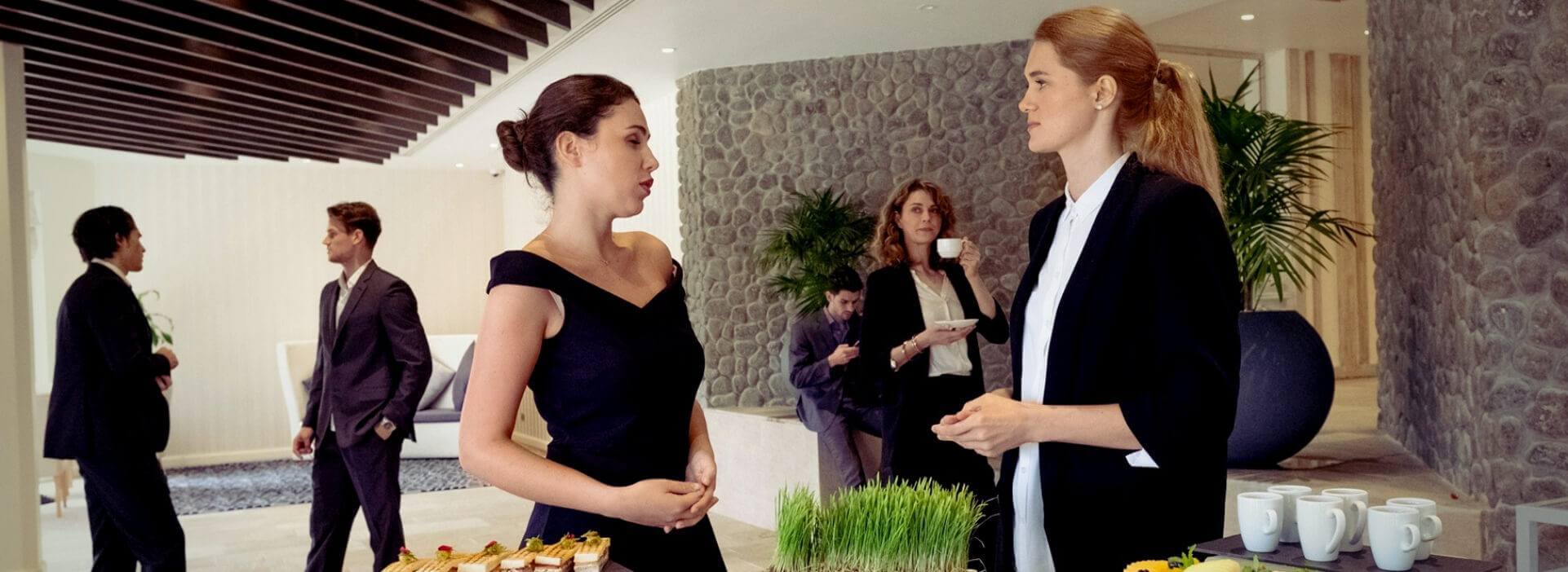 Business Women Talking in Lobby