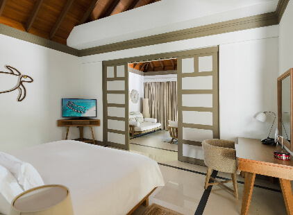 JA_Manafaru_Accommodation_Deluxe Beach Villa_Bedroom_2024.jpg