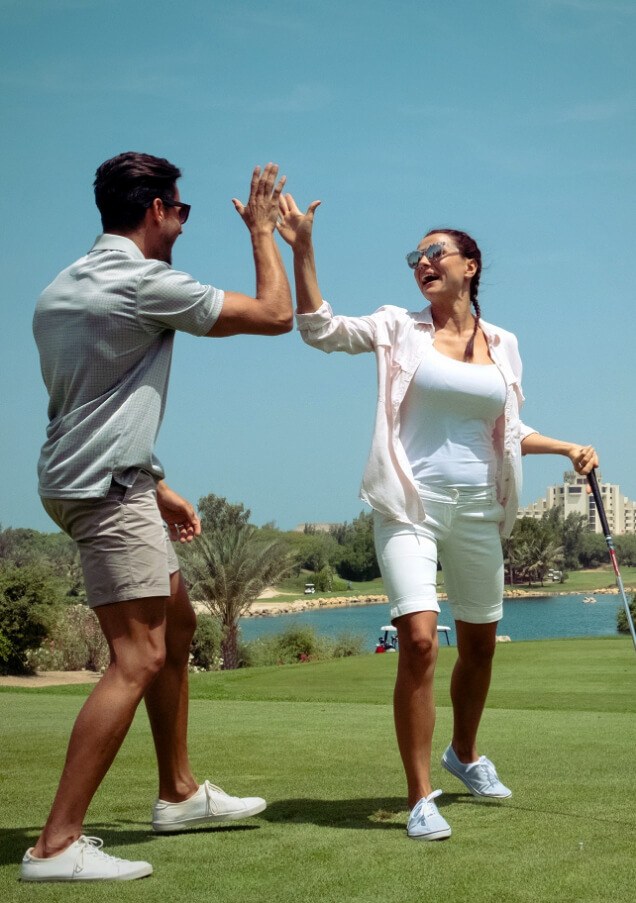 Couple Celebrating On Golf Course