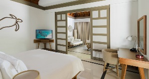 JA_Manafaru_Accommodation_Deluxe Beach Villa_Bedroom_2024.jpg