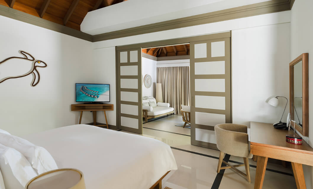 JA_Manafaru_Accommodation_Deluxe Beach Villa_Bedroom_2024.jpg