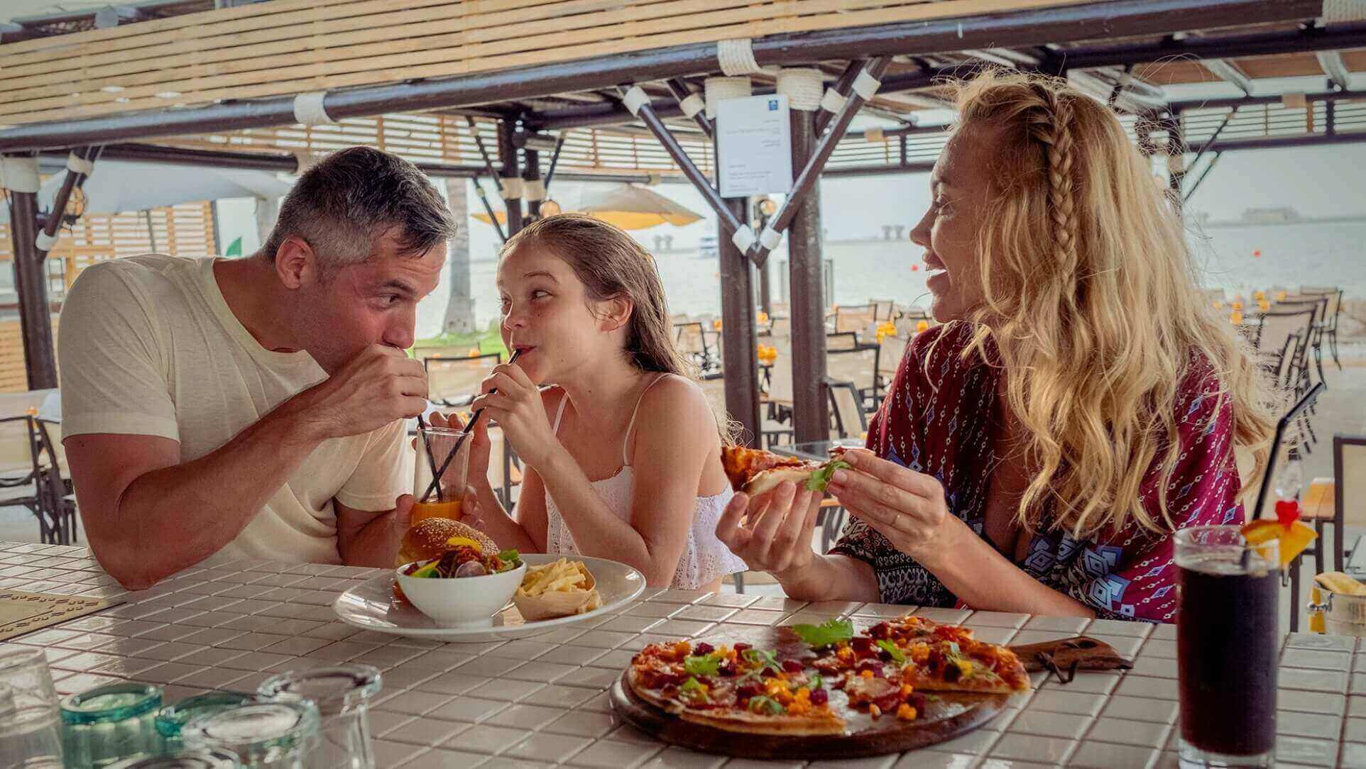 Family Eating Burgers And Pizza