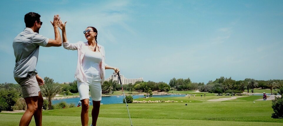 Couple Celebrating On Golf Course
