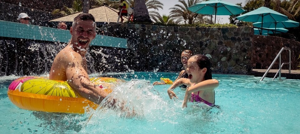 Family Splashing In Pool