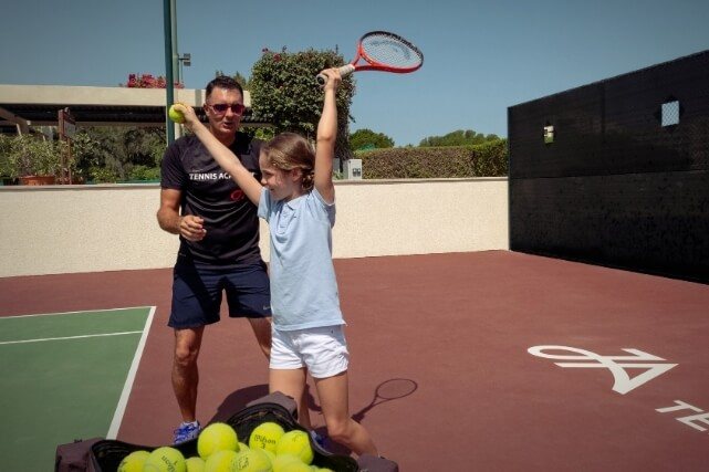 Girl Learning to Play Tennis