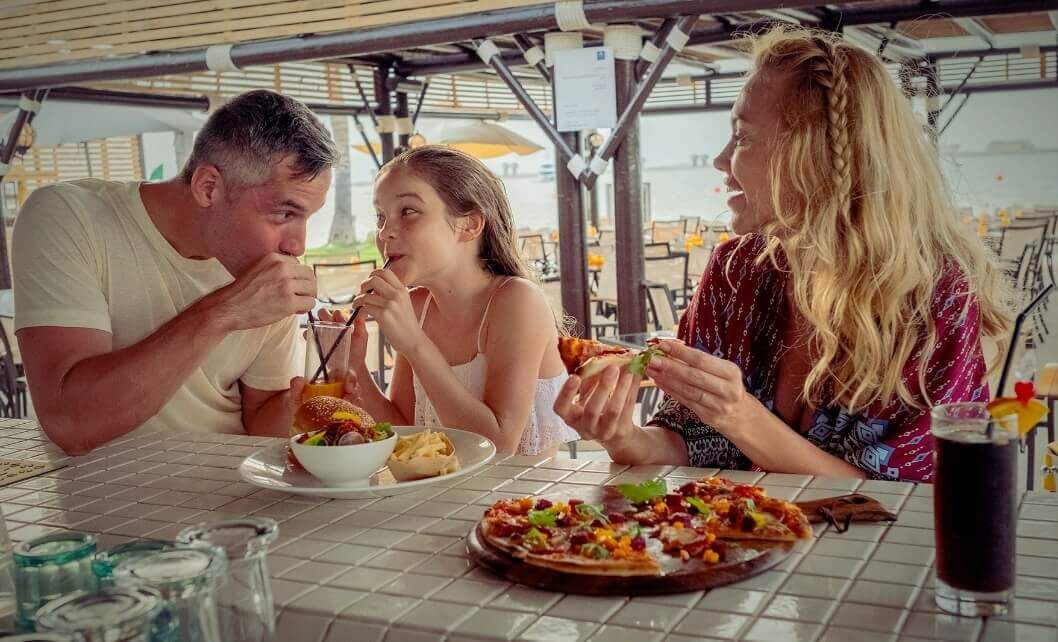 Family Eating Burgers And Pizza