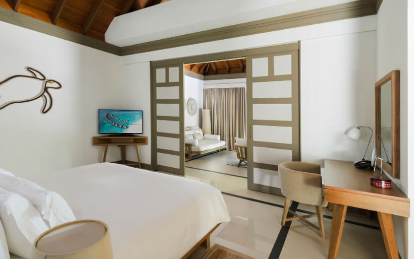 JA_Manafaru_Accommodation_Deluxe Beach Villa_Bedroom_2024.jpg