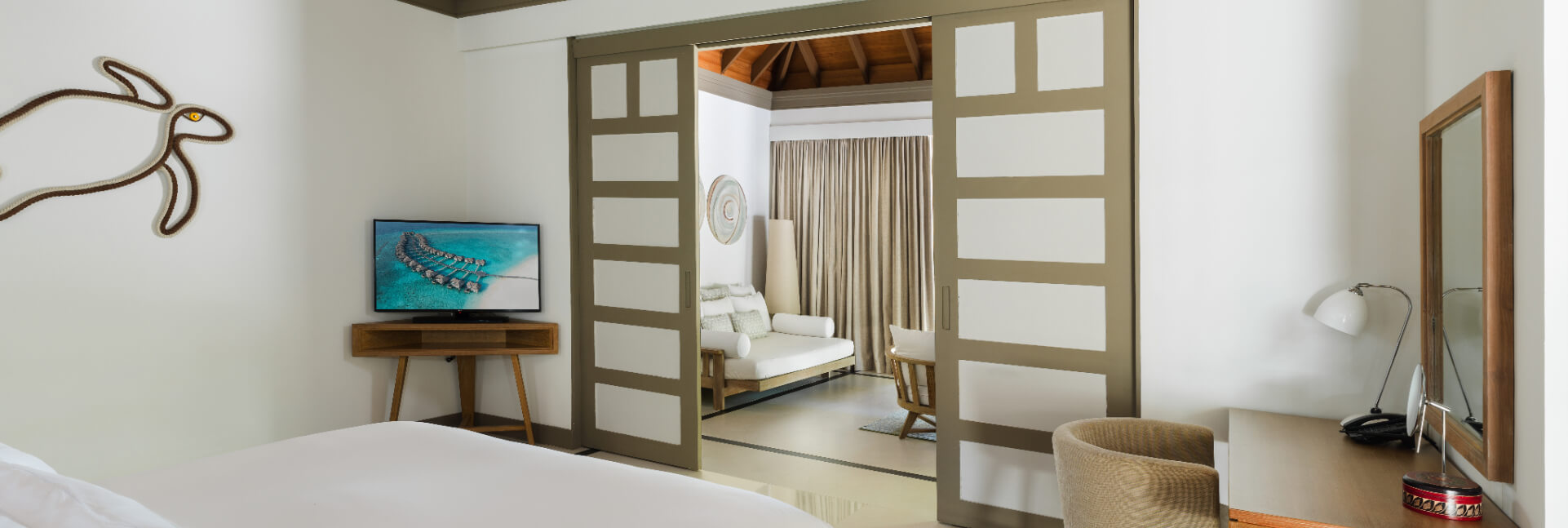 JA_Manafaru_Accommodation_Deluxe Beach Villa_Bedroom_2024.jpg