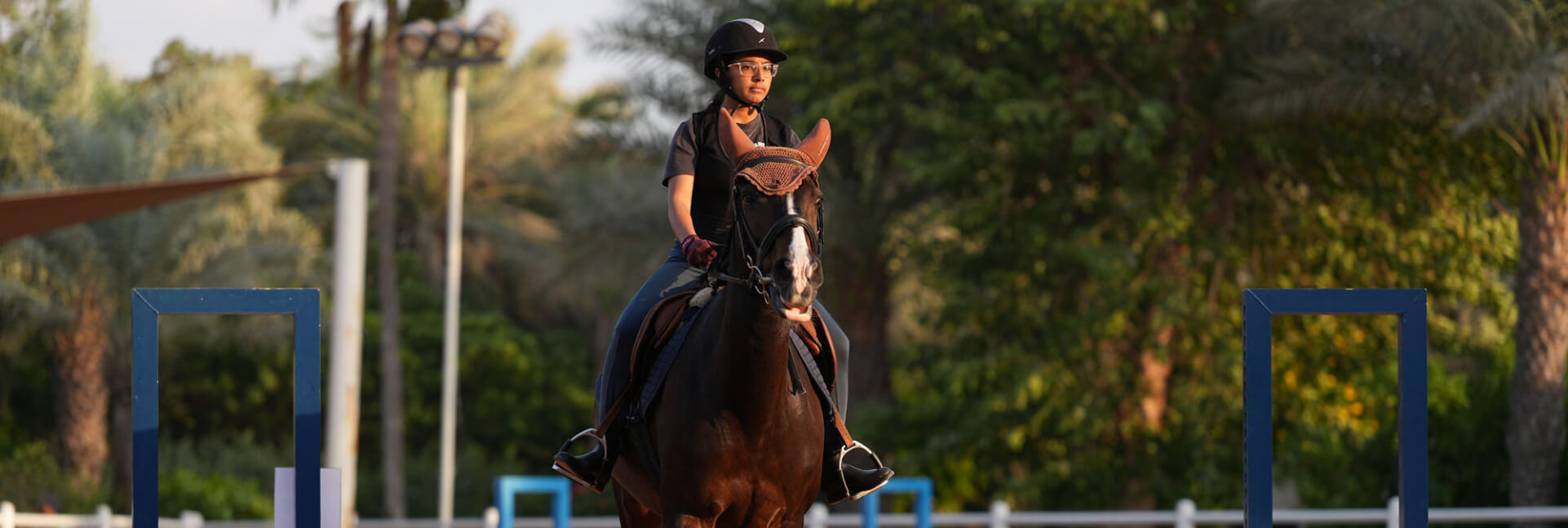 A girl riding a horse on a track